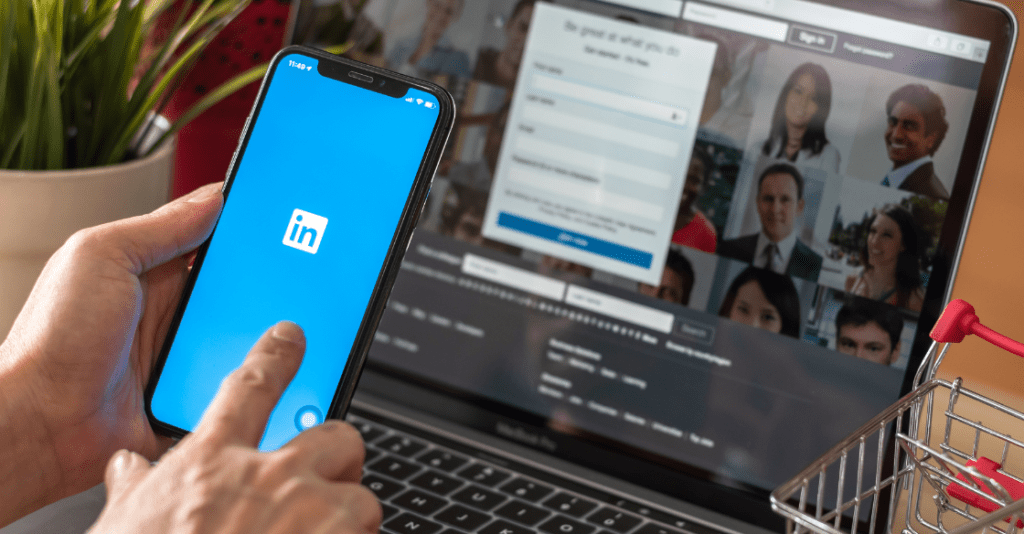 Hiring employer opens up LinkedIn app on phone to seek new potential employees.