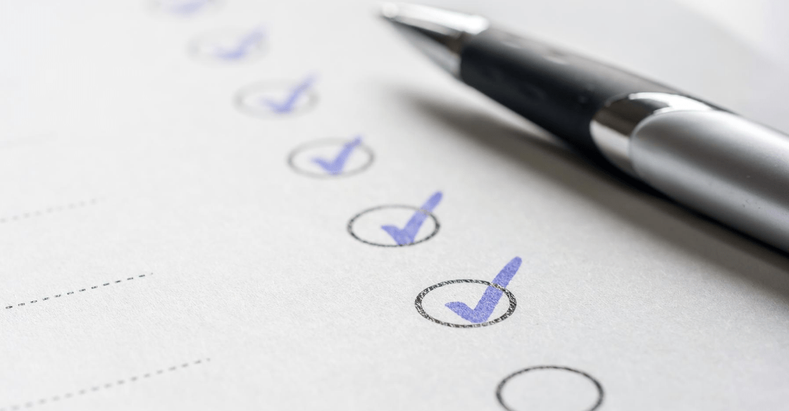 Small business employer checks a checklist for an applying employee that passes various background checks.
